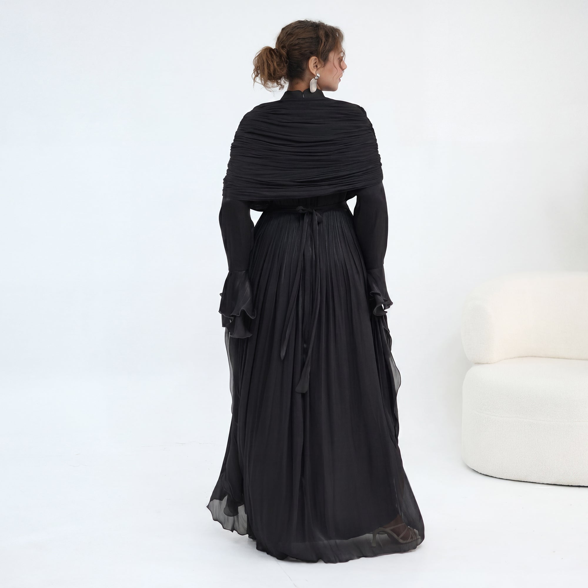 Double-layered dress with a waist-hugging design and a sleeveless vest, priced at 1169, without a headscarf