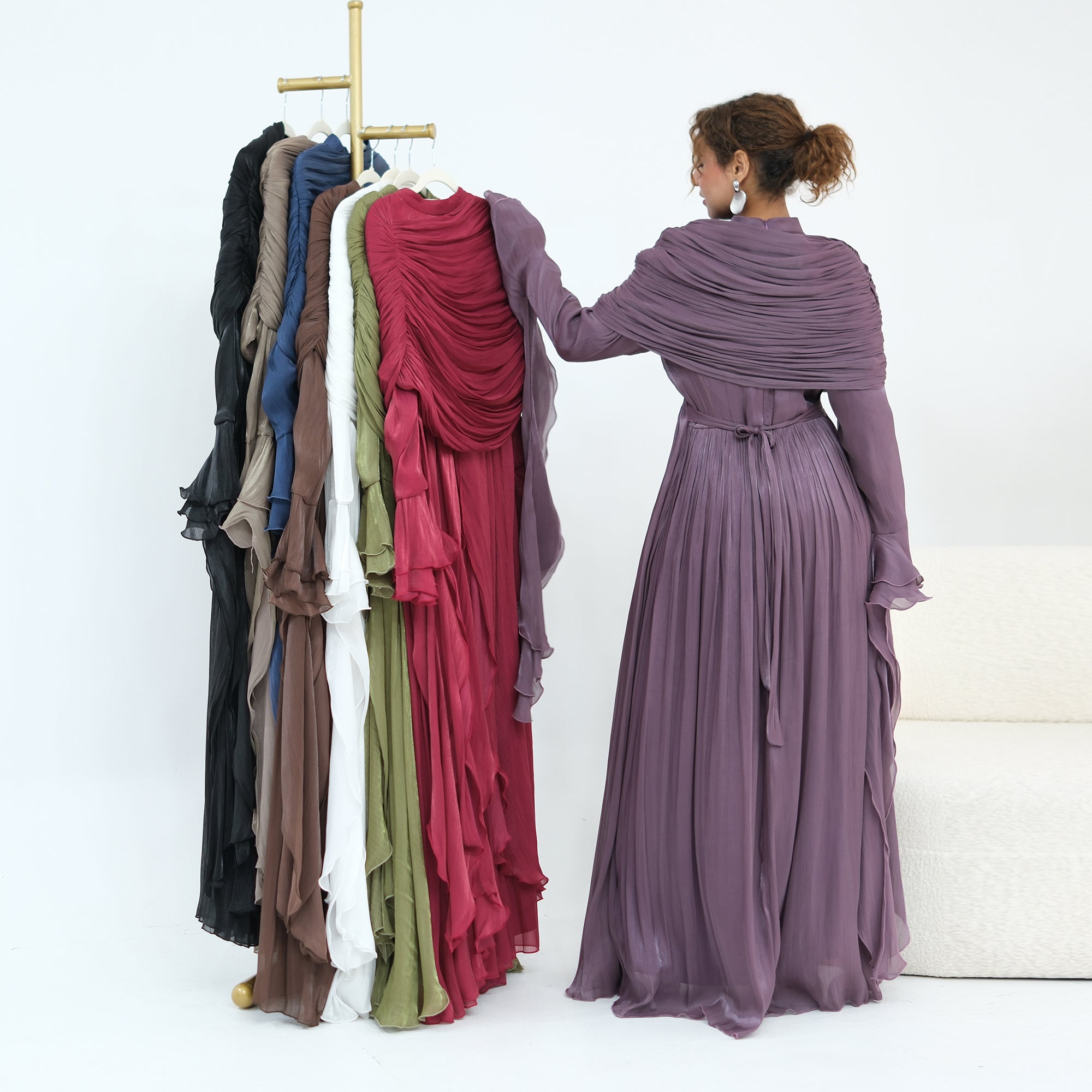 Double-layered dress with a waist-hugging design and a sleeveless vest, priced at 1169, without a headscarf